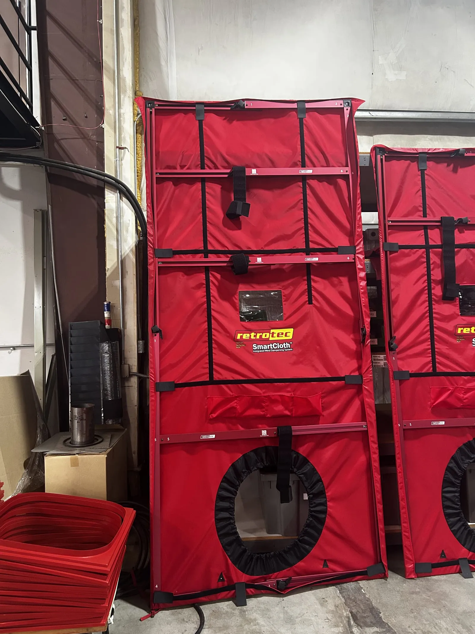 Retrotec blower door frames with red SmartCloth panels